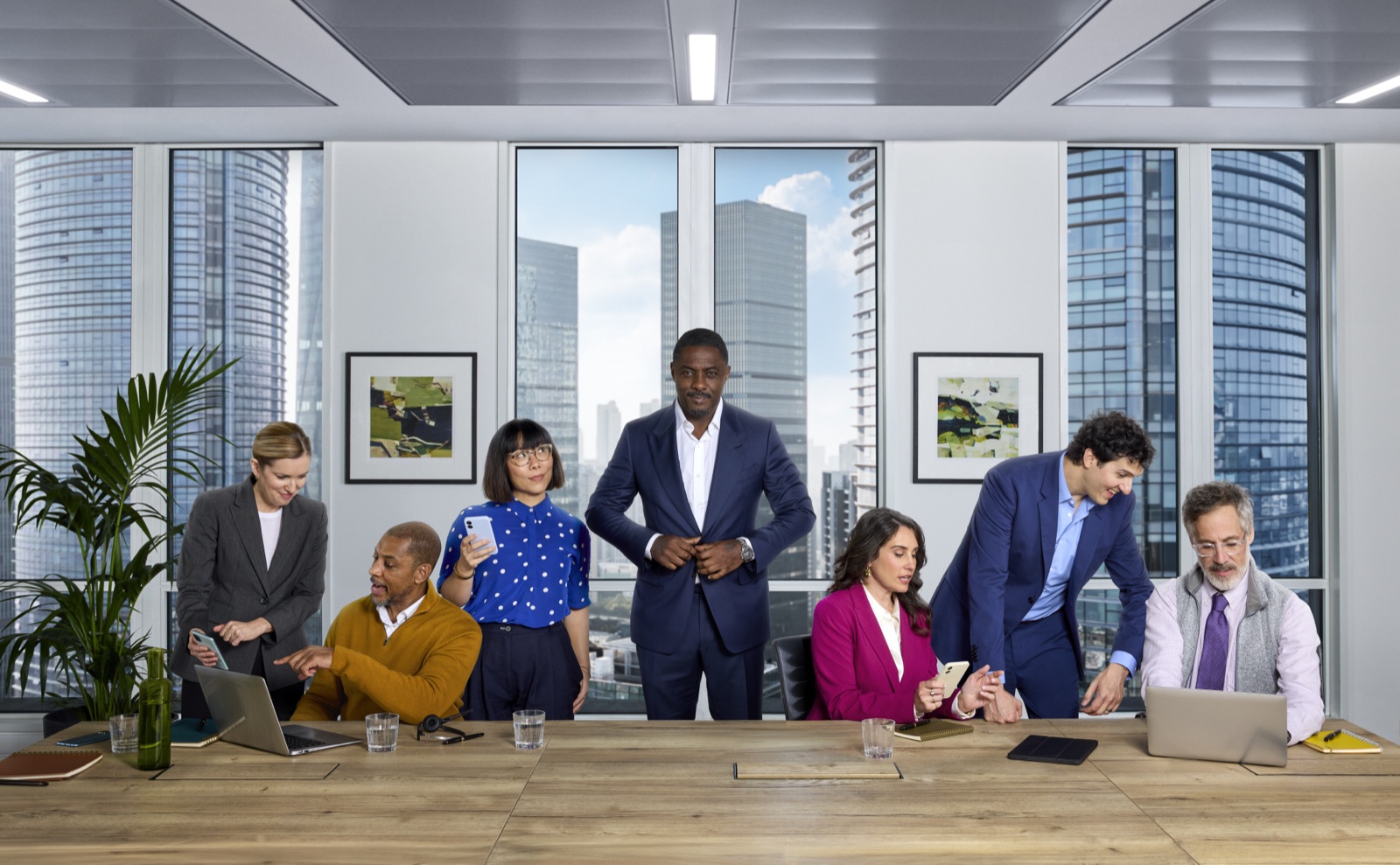 Idris Elba and the recurring ServiceNow cast around a boardroom table